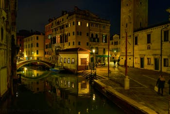 The Mondo Novo Canal reflections and the Santa Maria Formosa Bank in the Castello District in Venice.