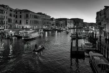 Water Buses and Gondolas on Venice Grand Canal seen from the Rialto Bridge.