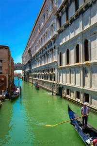 Gondolas on the Palazzo Canonica Canal, in front of the Bridge o Sighs and the Doge's Palace in Venice.