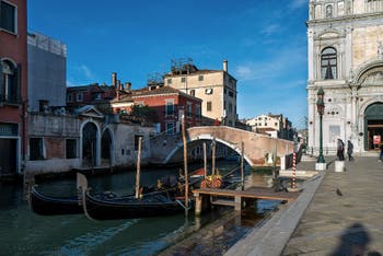 Gondolas on Mendicanti Canal in front of Cavallo Bridge in the Castello in Venice