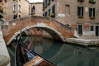 Gondola on the Miracoli Canal in front of the Santa Maria Nova Bridge in the Cannaregio district in Venice