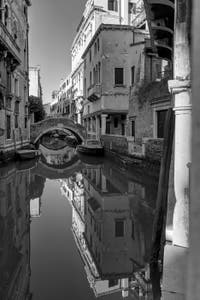 Venice Mirors: The Ca' Widmann Canal and Bridge in the Cannaregio District in Venice.