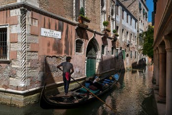 Gondola on Menuo o de la Verona Canal in Saint Mark district in Venice.