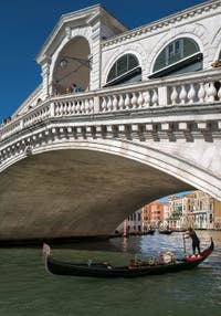 Gondola under the Rialto Bridge on Venice Grand Canal