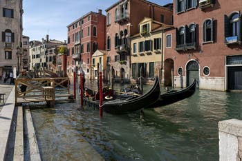 Gondolas on Mendicanti Canal near San Giovanni e Paolo Square in Castello district in Venice.