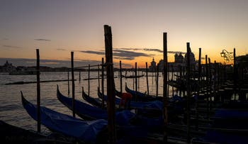 Gondolas at Saint-Mark in Venice at sunset.