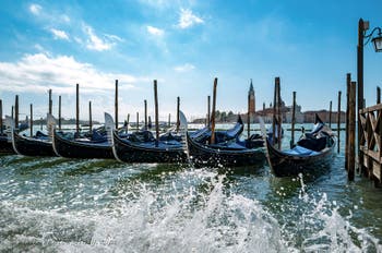 Gondolas on Saint-Mark pier in front of San Giorgio Maggiore Island in Venice.