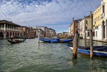 Gondolas and Santa Sofia Traghetto on Venice Grand Canal. 