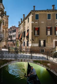 Gondola on the Santa Maria Formosa Canal under the Querini Bridge in the Castello district in Venice.
