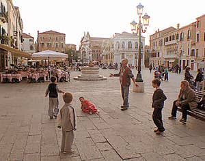 Children playing in the evening on the Campo Santo Stefano at Saint-Mark district