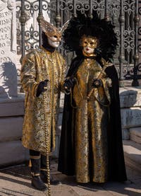 Costumes and Masks at the Venice Carnival, Prince and Princess of the Eagle in black and gold at the Arsenal.