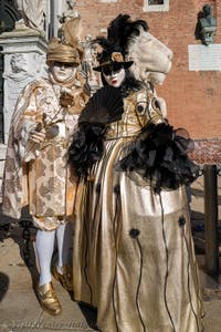 Nobles in black and gold at the Arsenal, the masks and costumes of the Venice Carnival. 