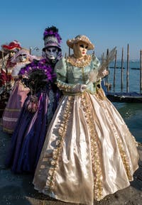 Elegant ladies in front of Saint Mark's Basin, the Masks and Costumes of the Venetian Carnival