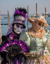 Elegant ladies in front of Saint Mark's Basin, the Masks and Costumes of the Venetian Carnival