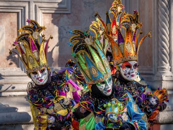 On the island of San Giorgio Maggiore, two magnificent costumes in glorious colours with Snow White and the Seven Dwarves on the princess's dress from the Venetian carnival.