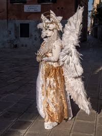 A costumed angel from the Venetian carnival on Campo Widmann in the Castello