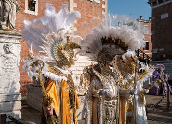 Venice Carnival costumes in front of the Venice Arsenale.