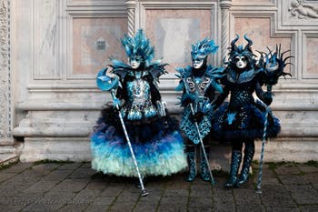 Venetian carnival costumed figures in front of the church of San Zaccaria.