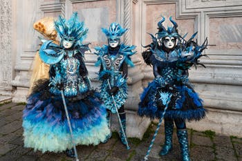 Venetian carnival costumed figures in front of the church of San Zaccaria.