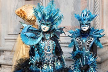 Venetian carnival costumed figures in front of the church of San Zaccaria.