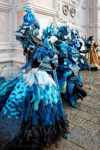 Venetian carnival costumed figures in front of the church of San Zaccaria.