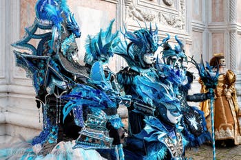 Venetian carnival costumed figures in front of the church of San Zaccaria.