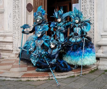 Venetian carnival costumed figures in front of the church of San Zaccaria.