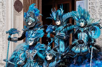 Venetian carnival costumed figures in front of the church of San Zaccaria.