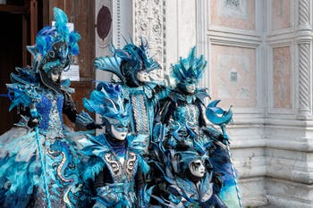 Venetian carnival costumed figures in front of the church of San Zaccaria.