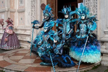 Venetian carnival costumed figures in front of the church of San Zaccaria.