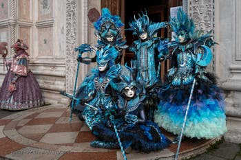 Venetian carnival costumed figures in front of the church of San Zaccaria.