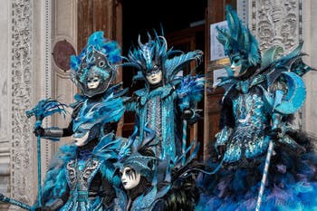 Venetian carnival costumed figures in front of the church of San Zaccaria.