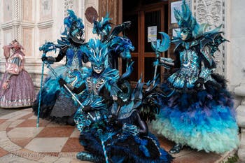 Venetian carnival costumed figures in front of the church of San Zaccaria.