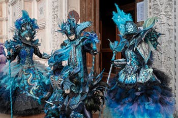 Venetian carnival costumed figures in front of the church of San Zaccaria.