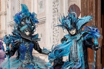 Venetian carnival costumed figures in front of the church of San Zaccaria.