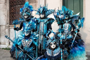 Venetian carnival costumed figures in front of the church of San Zaccaria.