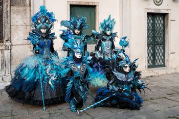 Venetian carnival costumed figures in front of the church of San Zaccaria.