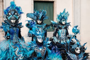 Venetian carnival costumed figures in front of the church of San Zaccaria.