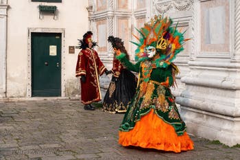 Venetian carnival costumed figures in front of the church of San Zaccaria.