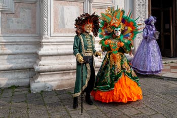 Venetian carnival costumed figures in front of the church of San Zaccaria.