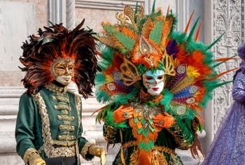 Venetian carnival costumed figures in front of the church of San Zaccaria.