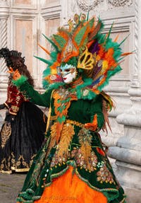 Venetian carnival costumed figures in front of the church of San Zaccaria.