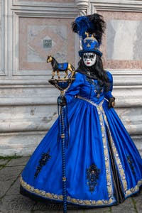 Venetian carnival costumed figures in front of the church of San Zaccaria.