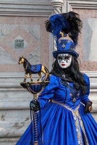 Venetian carnival costumed figures in front of the church of San Zaccaria.