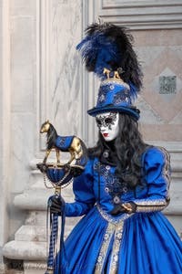 Venetian carnival costumed figures in front of the church of San Zaccaria.