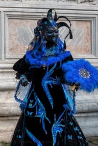 Venetian carnival costumed figures in front of the church of San Zaccaria.