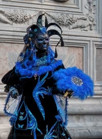 Venetian carnival costumed figures in front of the church of San Zaccaria.