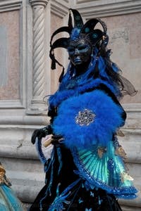 Venetian carnival costumed figures in front of the church of San Zaccaria.