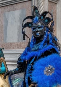 Venetian carnival costumed figures in front of the church of San Zaccaria.