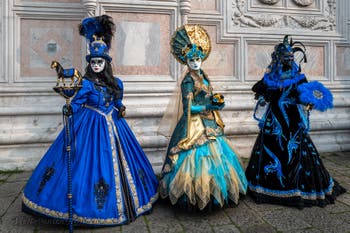 Venetian carnival costumed figures in front of the church of San Zaccaria.